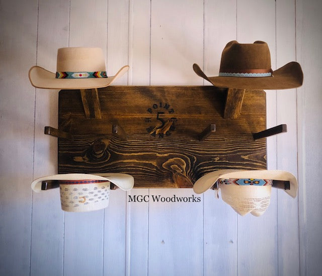 "High Noon" 6- Hat Cowboy Hat Rack handcrafted from dark stained pine holding six cowboy hats on a wall. 